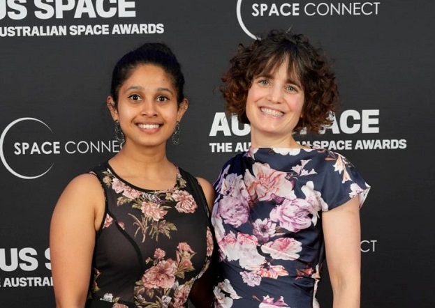Two women standing next to each other at an awards ceremony, including Roxane Bandini-Maeder on the right
