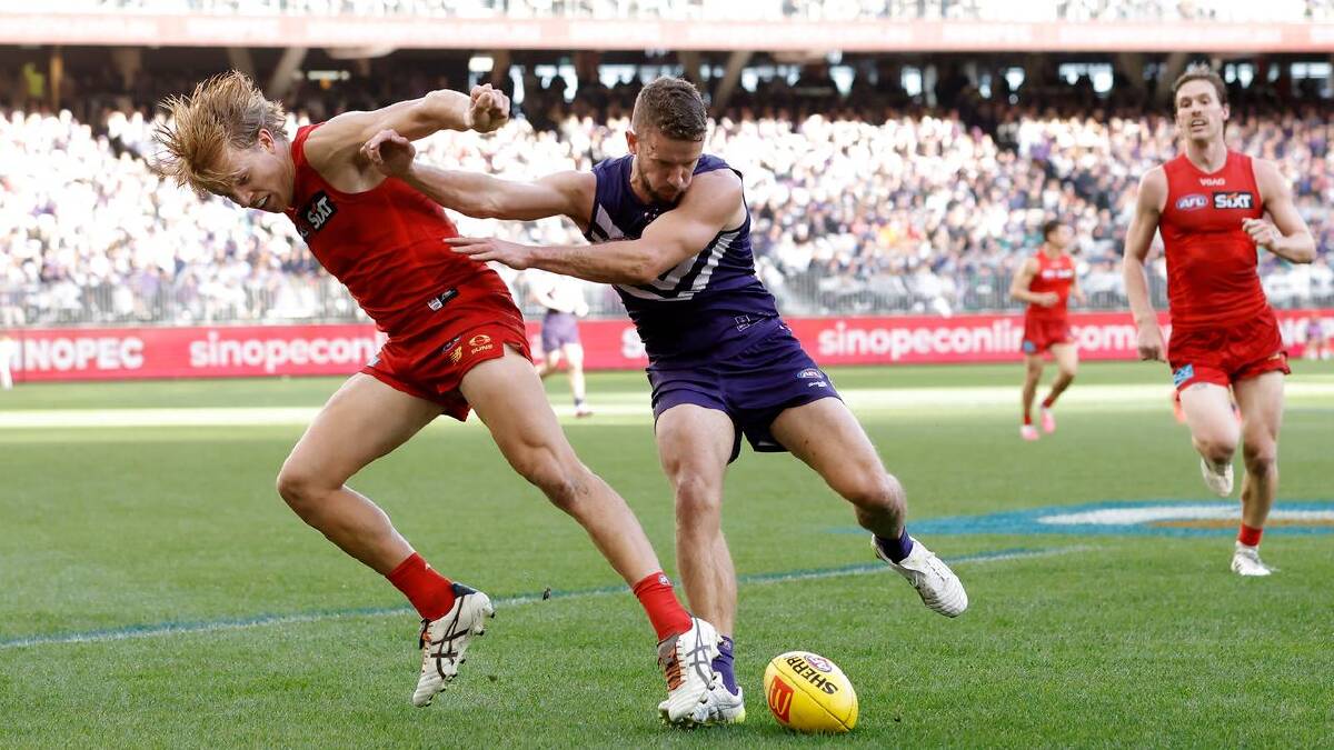 Sam Switkowski on Zeke Uwland: the Suns were manhandled by the Dockers at Optus Oval. (Richard Wainwright/AAP PHOTOS)