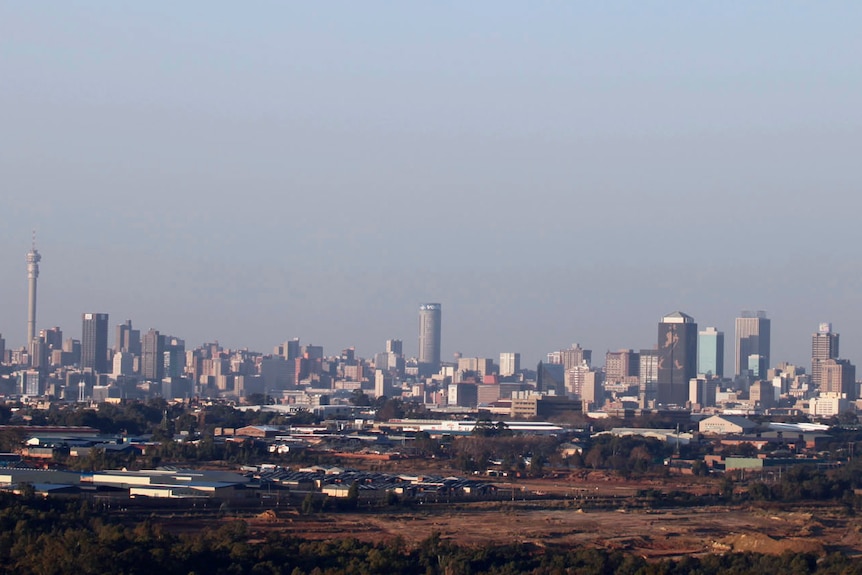 A modern city skyline as viewed from a distance.