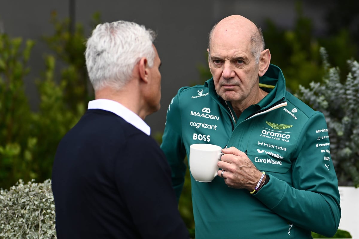 Adrian Newey scowling with a cup of coffee