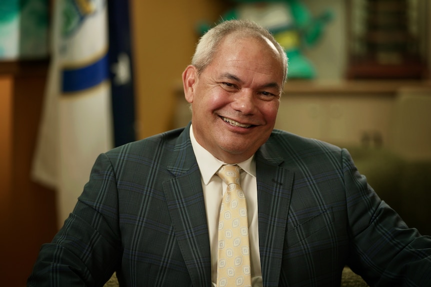 Man in suit smiles joyfully
