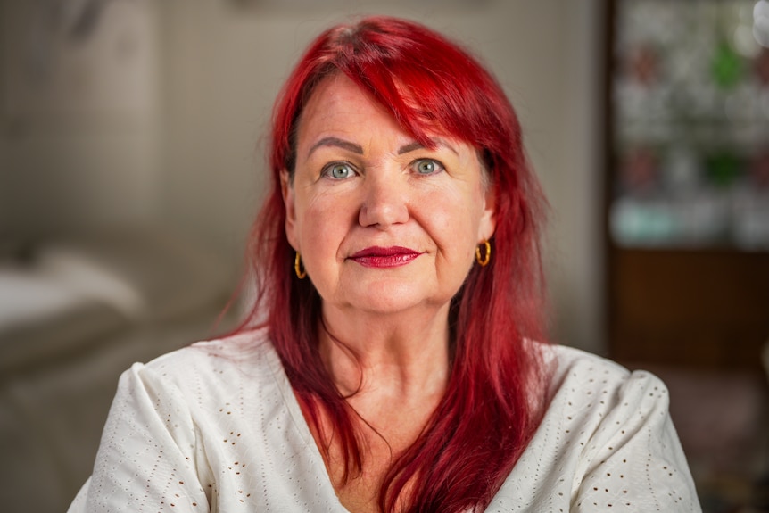 A woman looking straight ahead at the camera.