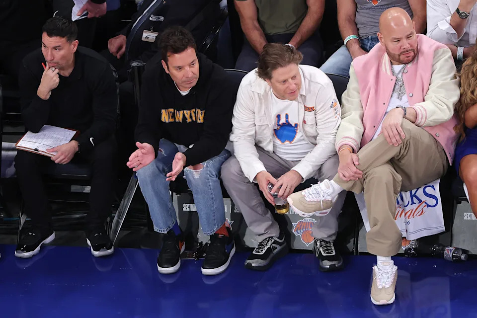 Jimmy Fallon, concert promoter Peter Shaprio and Fat Joe sitting courtside.