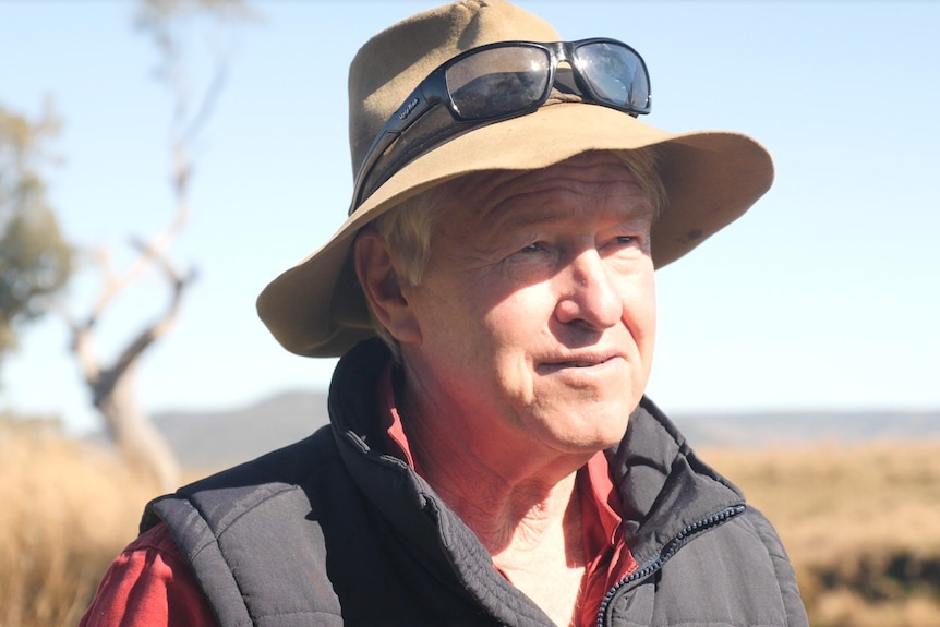 A man wearing an Akubra hat looks into middle distance