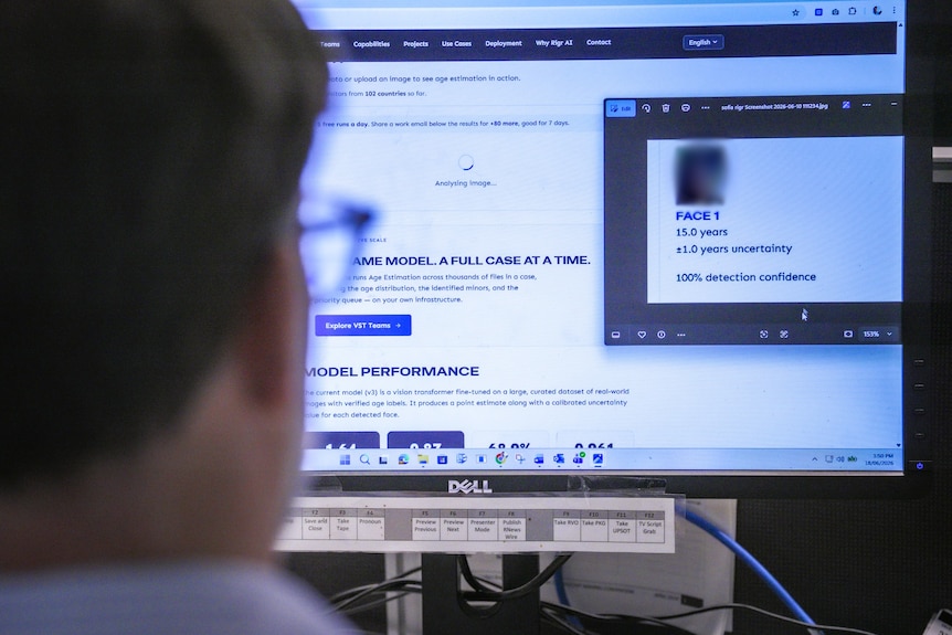 A journalist looks at a computer screen with an umage of a character on it and an age estimation that says 15 years.