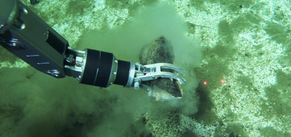 Fossil samples being collected by the robotic arm of the submersible