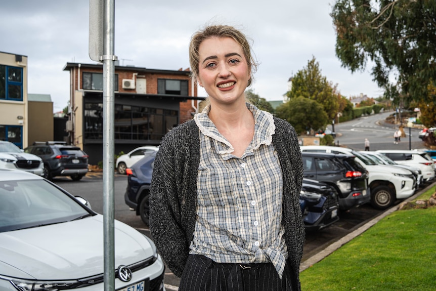 Woman standing in front of a carpark.
