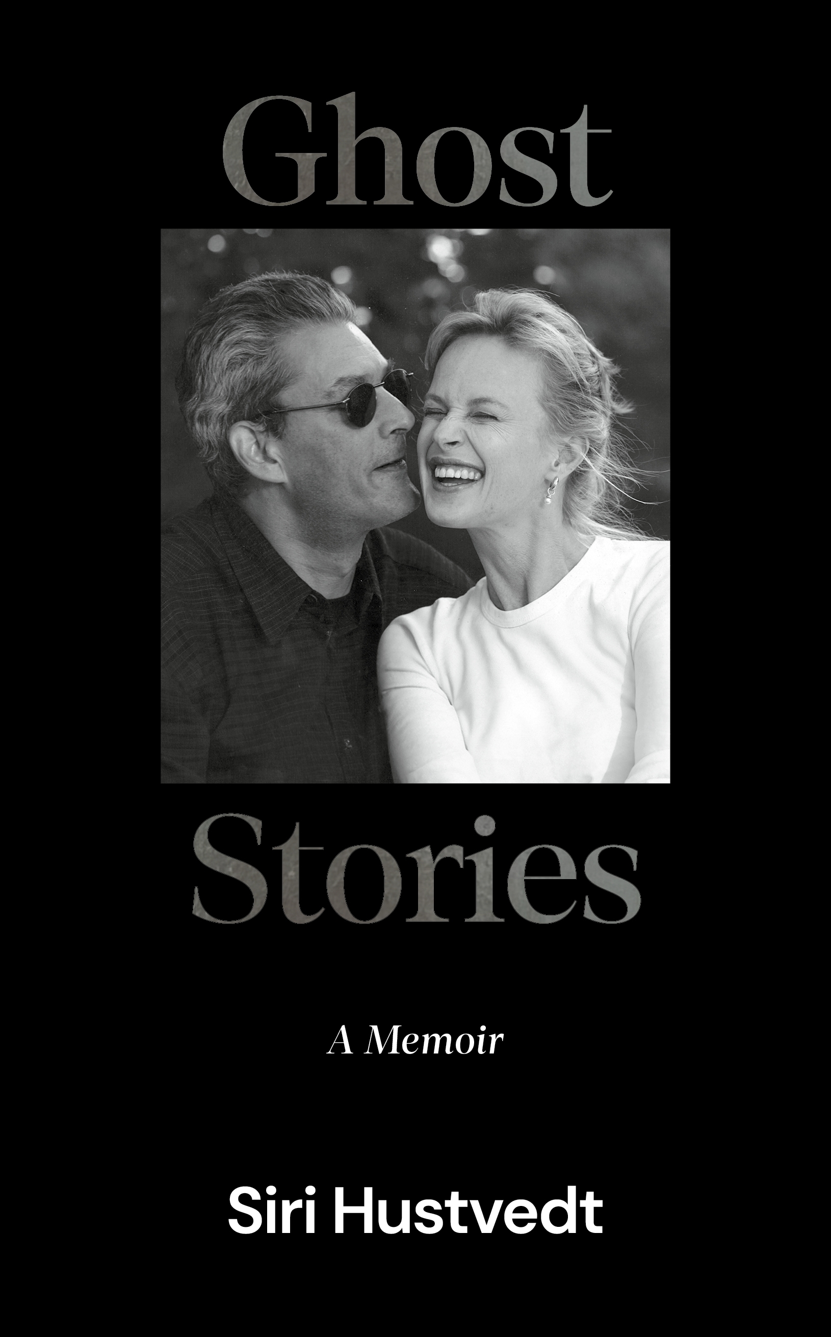 Cover of Ghost Stories by Siri Hustvedt; a black and white photo of a man and a woman looking happy together.