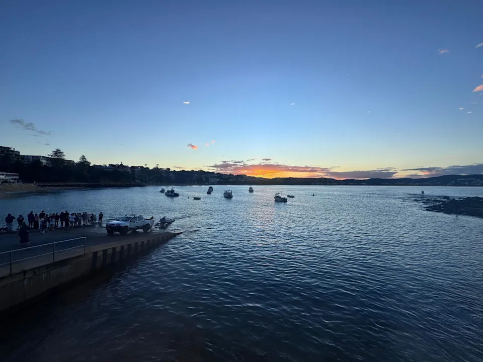 The sun going down over Terrigal, with the water prominent in the shot.