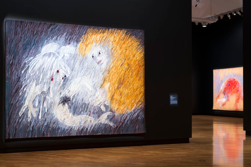 A large tapestry depicting a man laying his hands on another person to heal them.