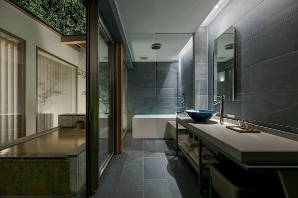 Some of the more luxurious rooms of Itomachi Hotel 0 include semi-outdoor blue stone onsen-stye baths.