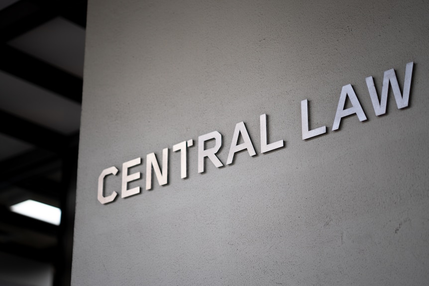Exterior of a court building featuring silver steel detailing, reading 'Central Law'