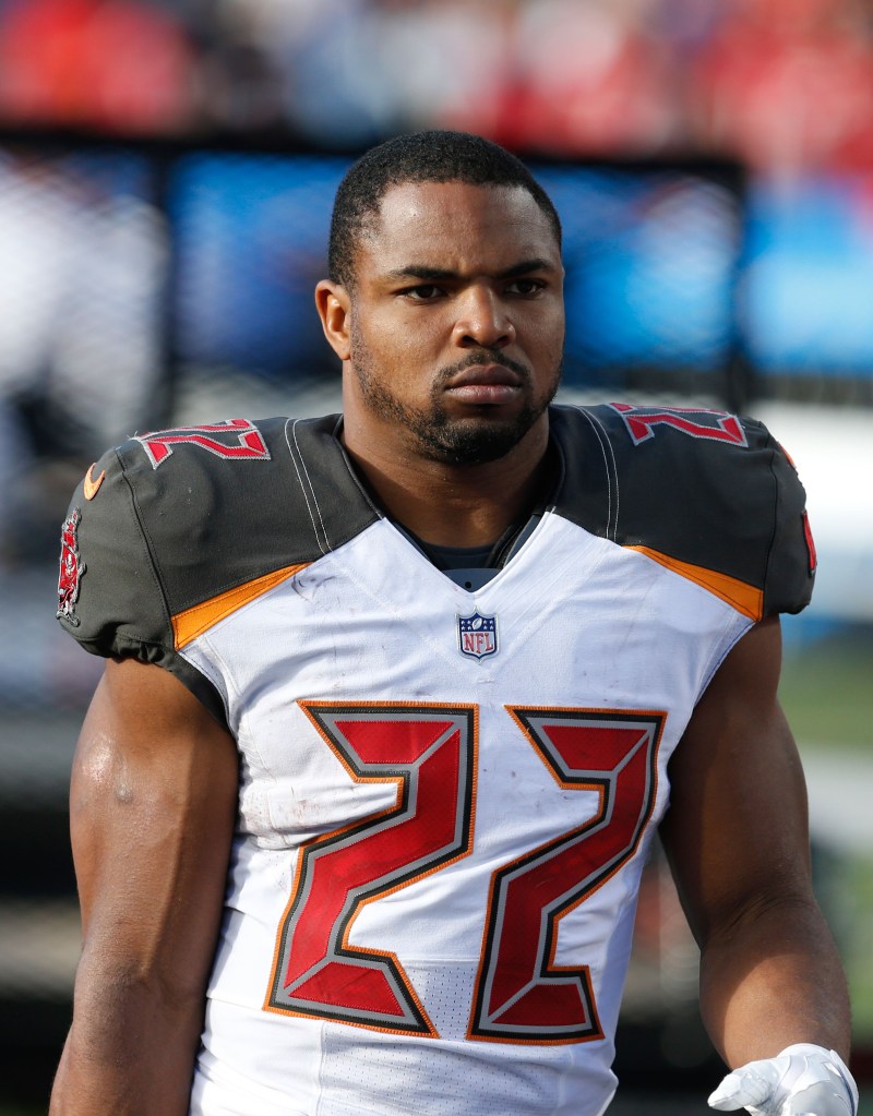 An NFL player in a white and dark gray jersey with the number 22.