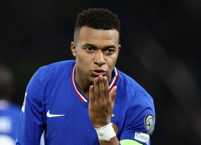 Mbappe kisses his hand in celebration