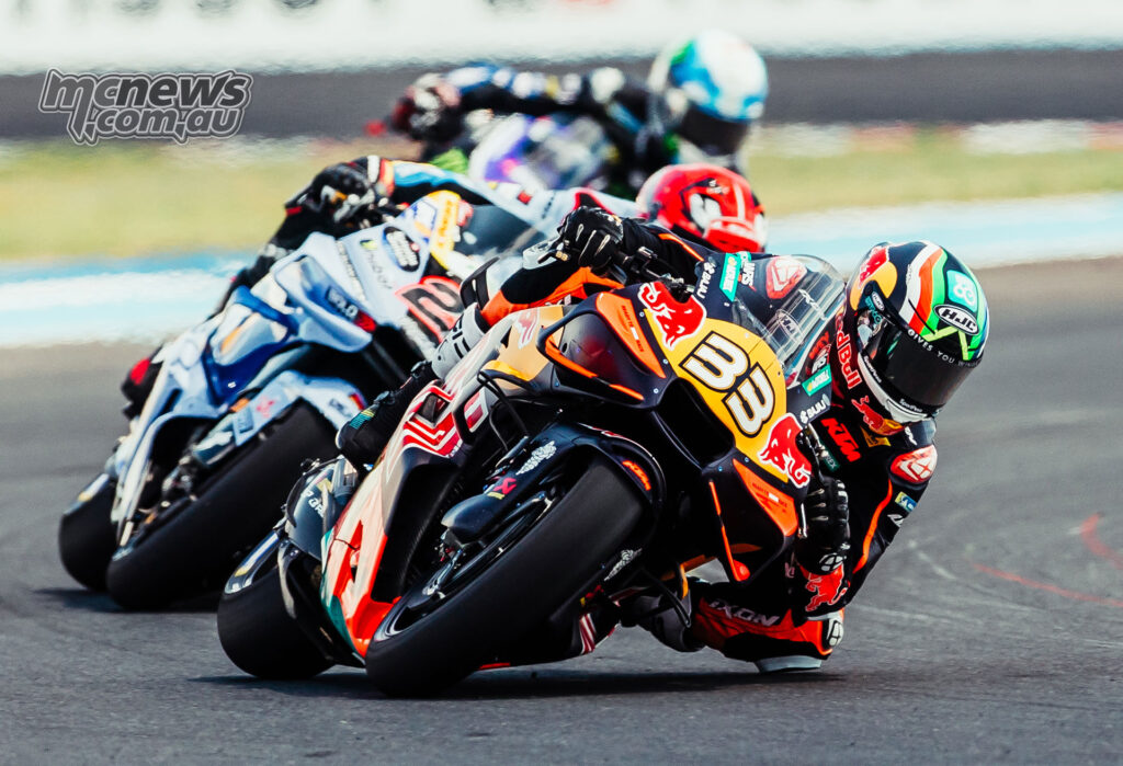 Brad Binder leads Iker Lecuona and other MotoGP riders through a corner at Balaton Park.