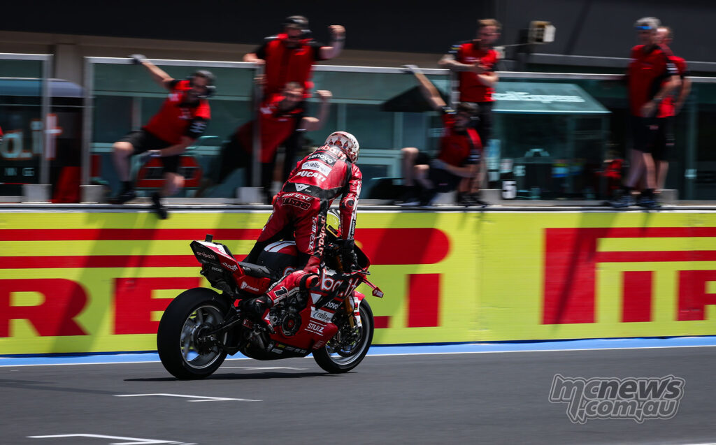 Nicolò Bulega celebrating on the Ducati in front of the Aruba.it Racing team wall at Misano.