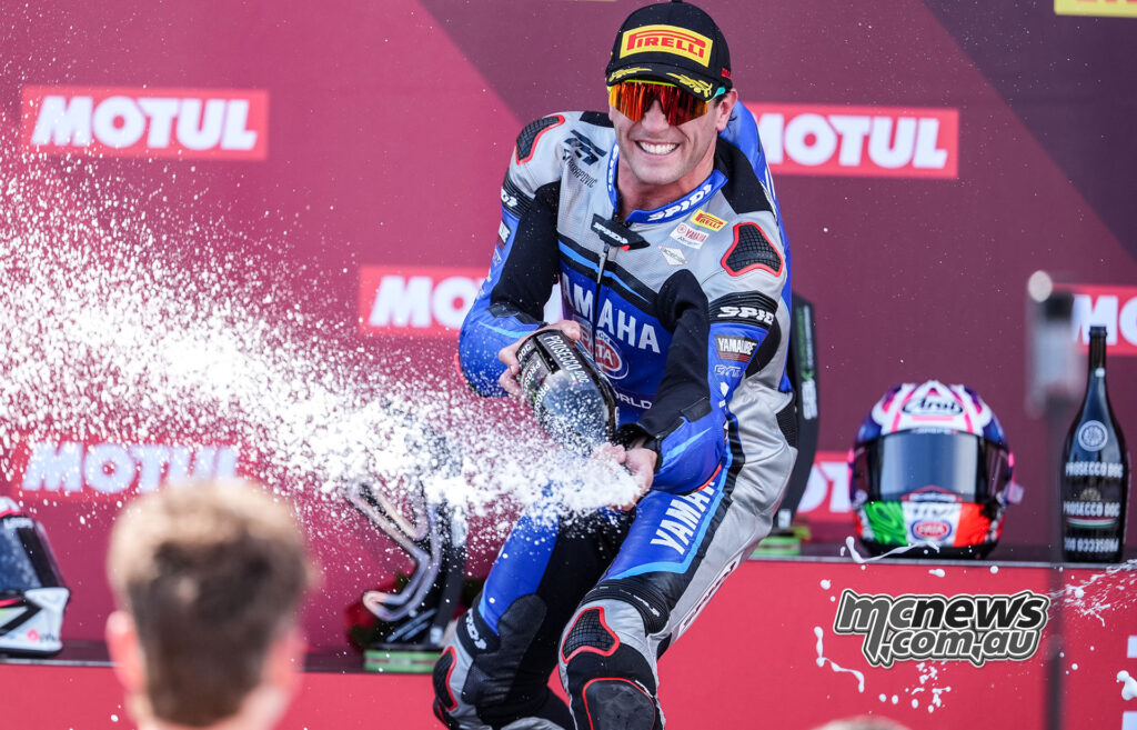 Albert Arenas spraying Prosecco on the podium after winning WorldSSP Race 2 at Misano.