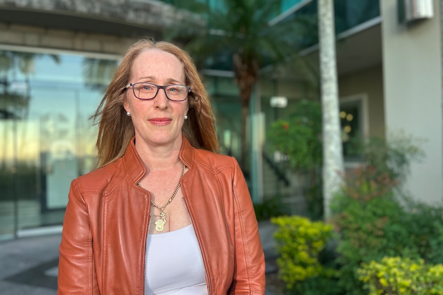 A woman with glasses and a jacket on