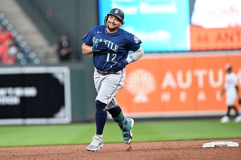 Seattle Mariners' Josh Naylor (12) smiles as he rounds second base after hitting a grand slam against the Baltimore Orioles in the fifth inning of a baseball game, Monday, June 8, 2026, in Baltimore. (AP Photo/Gail Burton)