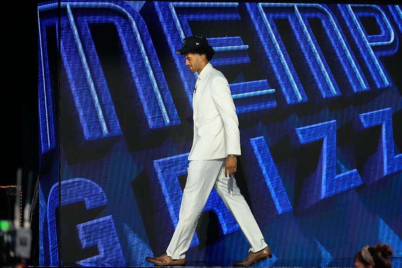 Cameron Boozer gestures as he walks off the stage after being chosen by the Memphis Grizzlies in the first round of the NBA basketball draft, Tuesday, June 23, 2026, in New York. (AP Photo/Yuki Iwamura)