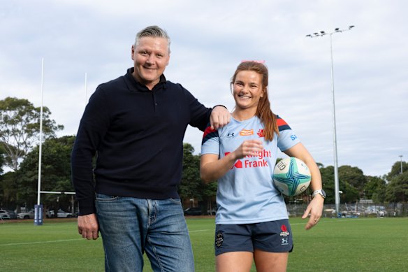 Matt Burke and Edie Burke posing together at Waratahs headquarters, ahead of Edie’s starting debut for NSW.