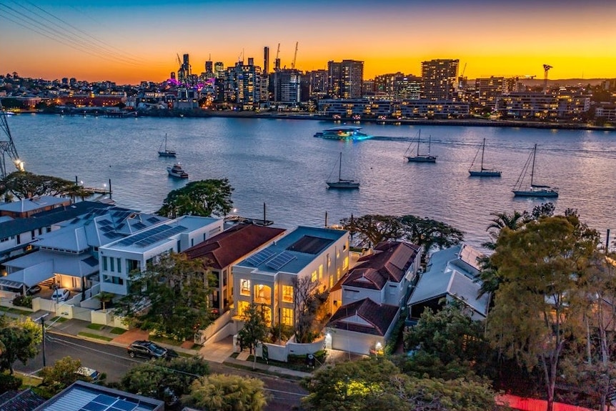 A sunset picture of mansions on the river in Bulimba, Brisbane.
