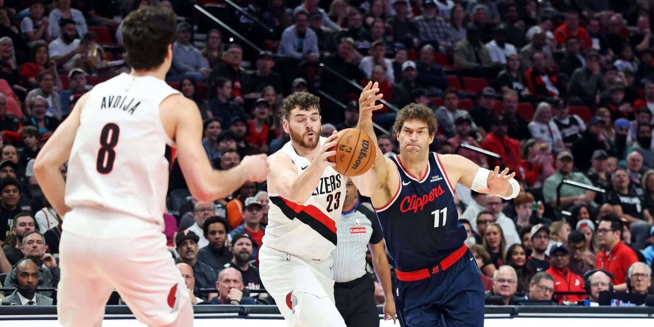 Portland's Donovan Clingan and LA's Brook Lopez go after a loose ball.