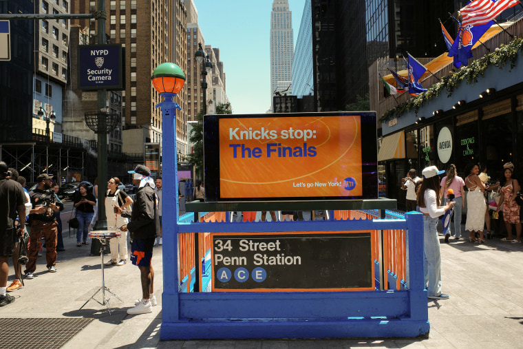 Madison Square Garden Subway Station is decorated in the orange and blue colors of the New York Knicks.