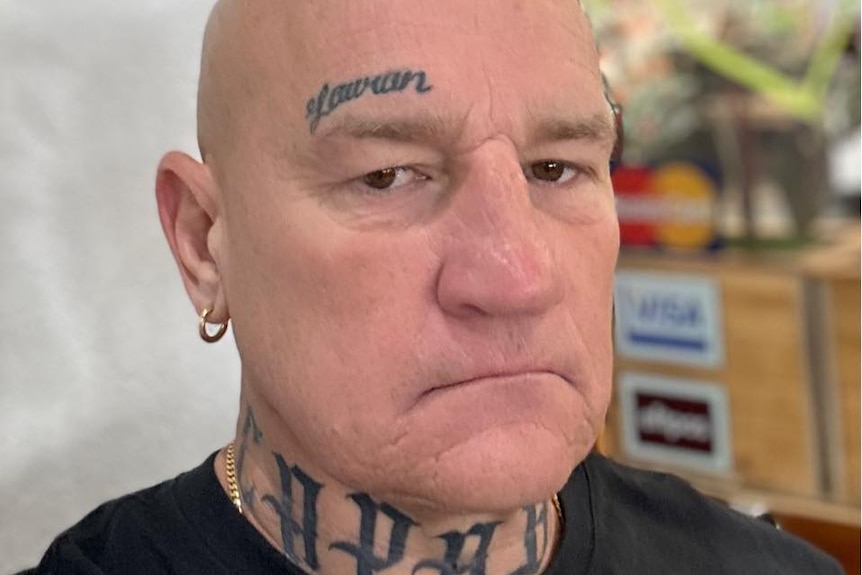 Crime figure Gavin Preston looks unsmilingly into the camera as he poses for a photo.