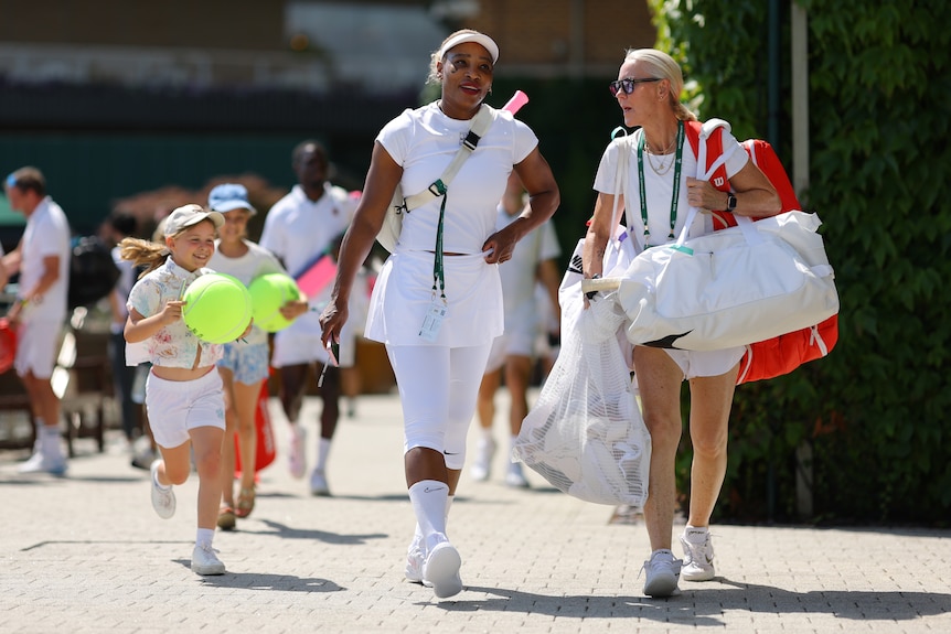 Young fans chase after Serena Williams as she walks with Rennae Stubbs at Wimbledon.