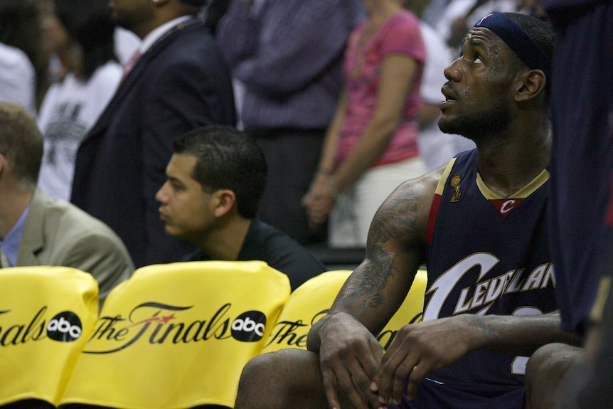LeBron James looks upwards while sitting down