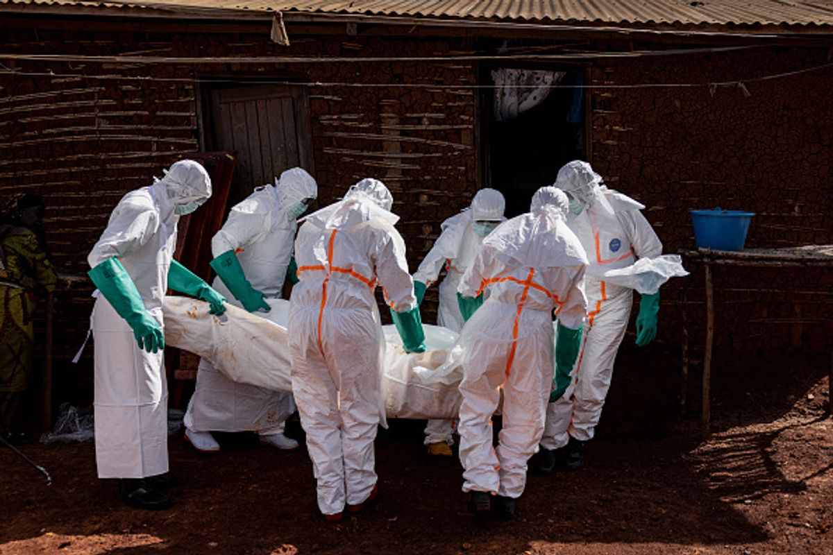 MONGBWALU, DEMOCRATIC REPUBLIC OF CONGO - MAY 24: Health workers wearing protective equipment carry the body of a suspected Ebola victim during safe burial procedures outside a family home in the community of Mongbwaluon May 24, 2026