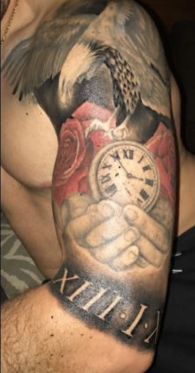 Anoher tattoo on his upper left arm of a hands holding a clock face.
