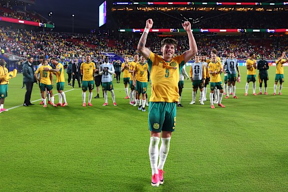 Jordan Bos and the Socceroos celebrate after their draw with Paraguay secured a place in the World Cup knockout stage.