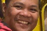 A close-up photo of Jessie James Tumaliuan smiling at the camera.