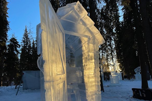 A skeleton in a dunny reading a newspaper - a piece Kevin Kapusi Starow and a colleague carved for the World Ice Art Championships in Fairbanks, Alaska.