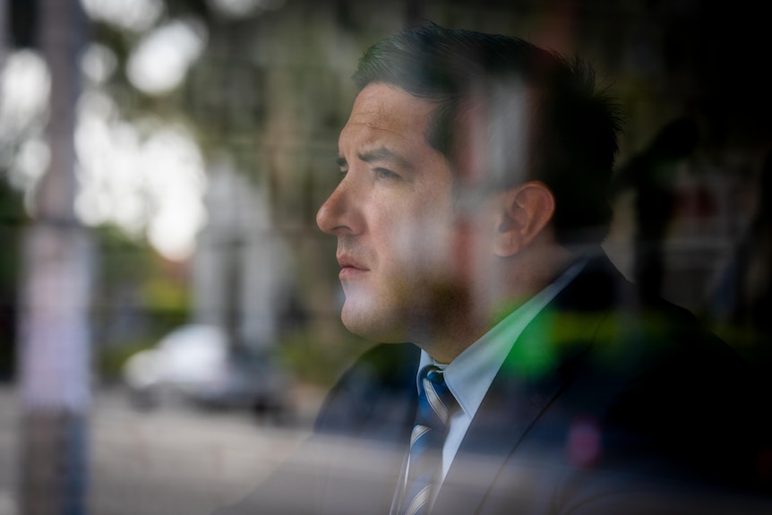 A man looking through a window