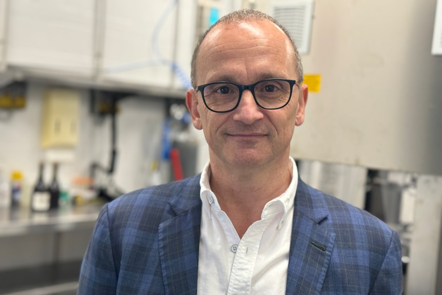 A man in glasses and a suit.
