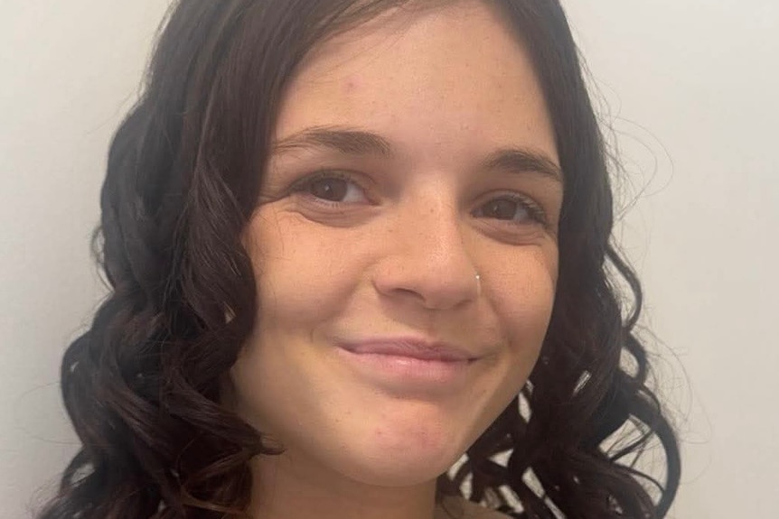A headshot of a teenage girl, smiling