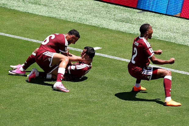 Boualem Khoukhi of Qatar celebrates his goal.