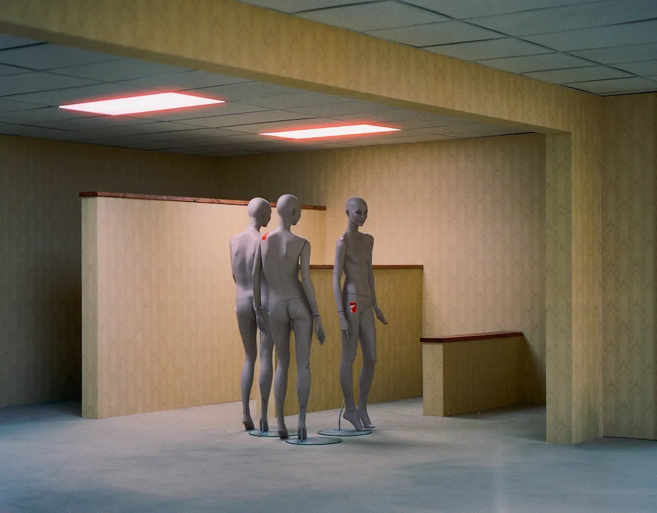 The concept describes a series of infinite rooms, populated by pale yellow wallpaper, carpeted floors, and random pieces of furniture.