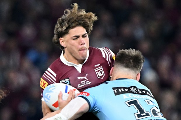 Reece Walsh of the Maroons is tackled by Angus Crichton of the Blues in the first half of Origin III.