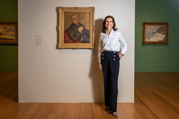 Claire Durand-Ruel pictured with a portrait of Paul Durand-Ruel by Auguste Renoir