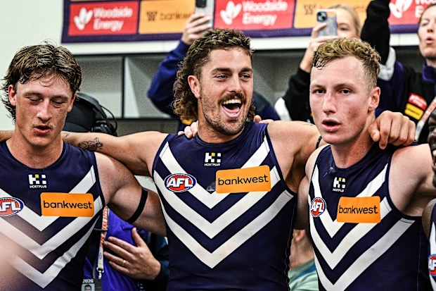 Luke Jackson, Jye Amiss and Josh Treacy sing the Fremantle song after a win.