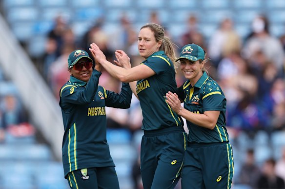 Ellyse Perry (centre) celebrates with captain Sophie Molineux (right) and Alana King after taking a wicket against Bangladesh.