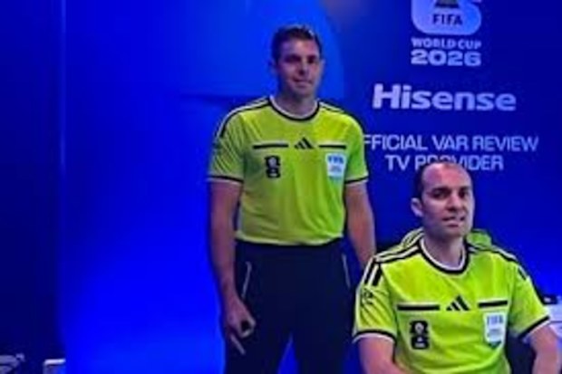 Australian ref Shaun Evans makes the gesture on worldwide television.