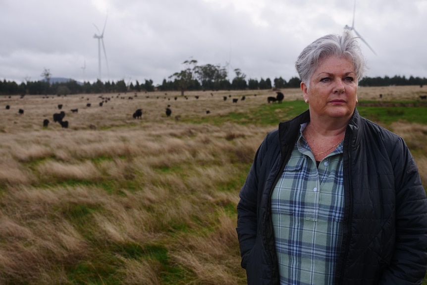 A woman poses on a farm