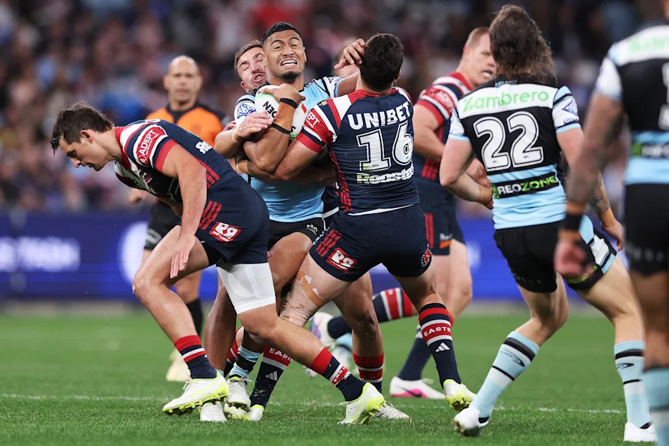 Pictured here, Sharks winger Ronaldo Mulitalo playing against the Roosters in Sunday night's NRL defeat.