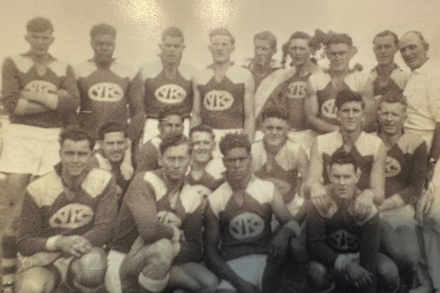 Black and white historic photo of a men's football team.