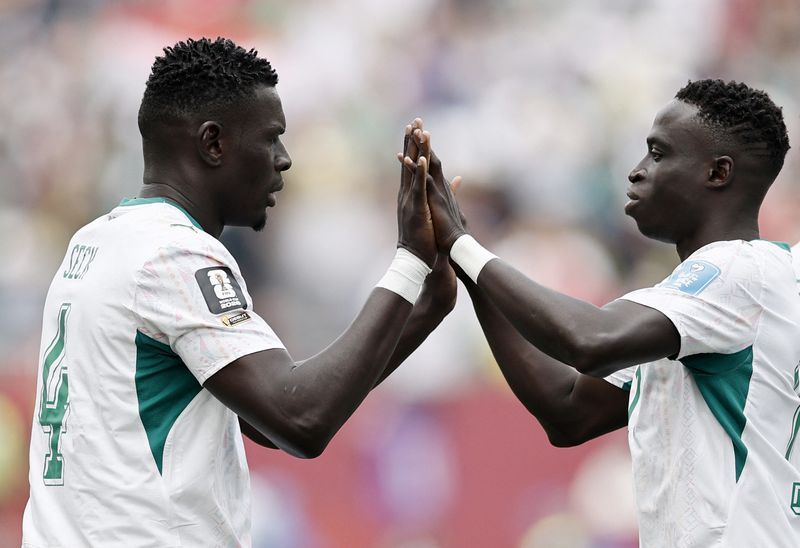 Football: Soccer-Gueye double helps five-star Senegal keep World Cup hopes alive and send Iraq home